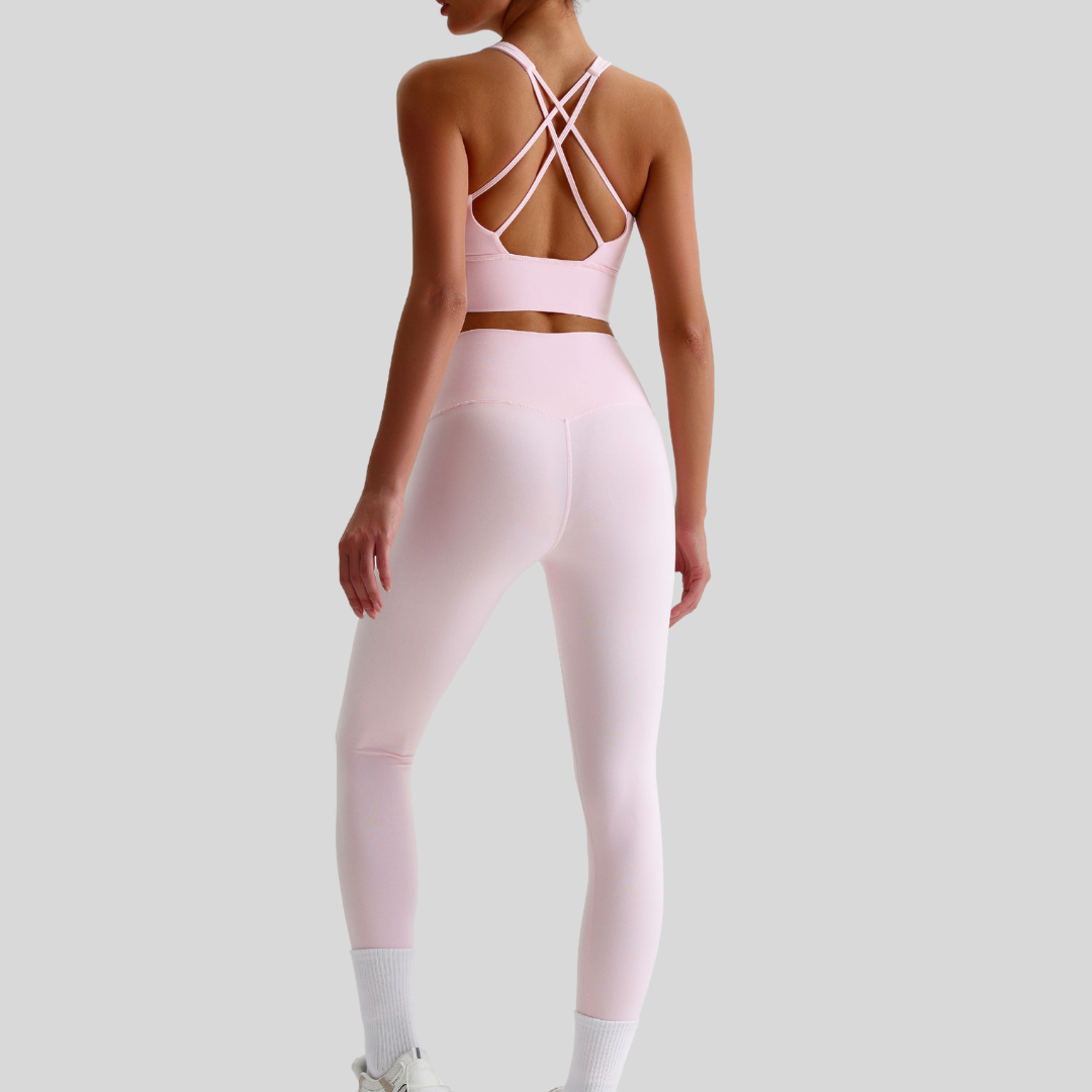 Back view of Kaos The Label Isla Set in Pink, featuring crisscross sports bra straps and high-waisted leggings