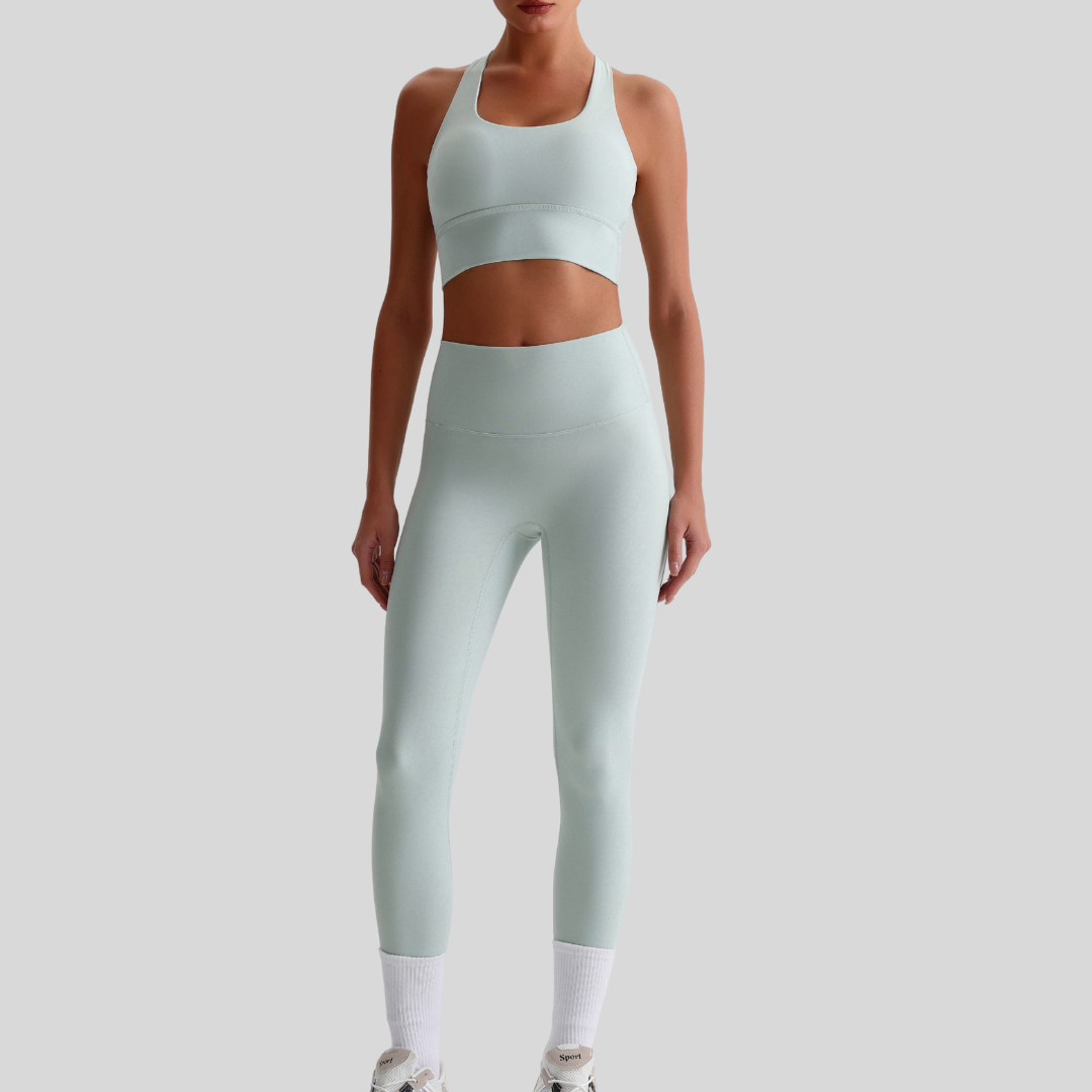 Model wearing Kaos The Label Isla Set in Light Green, showcasing front view of seamless activewear set