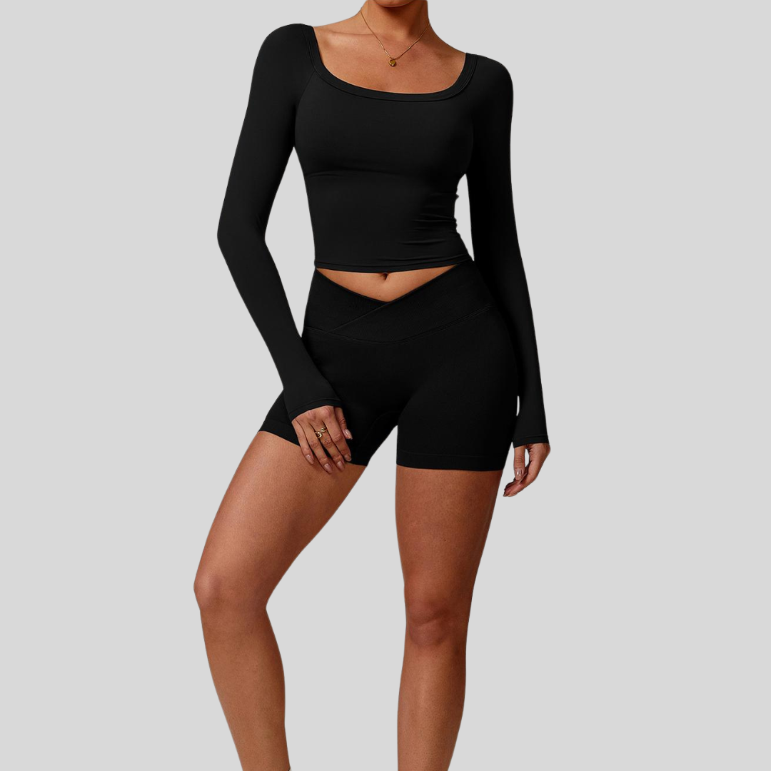 Model wearing Kaos The Label Cleo Set in Black, showcasing front view of seamless activewear set