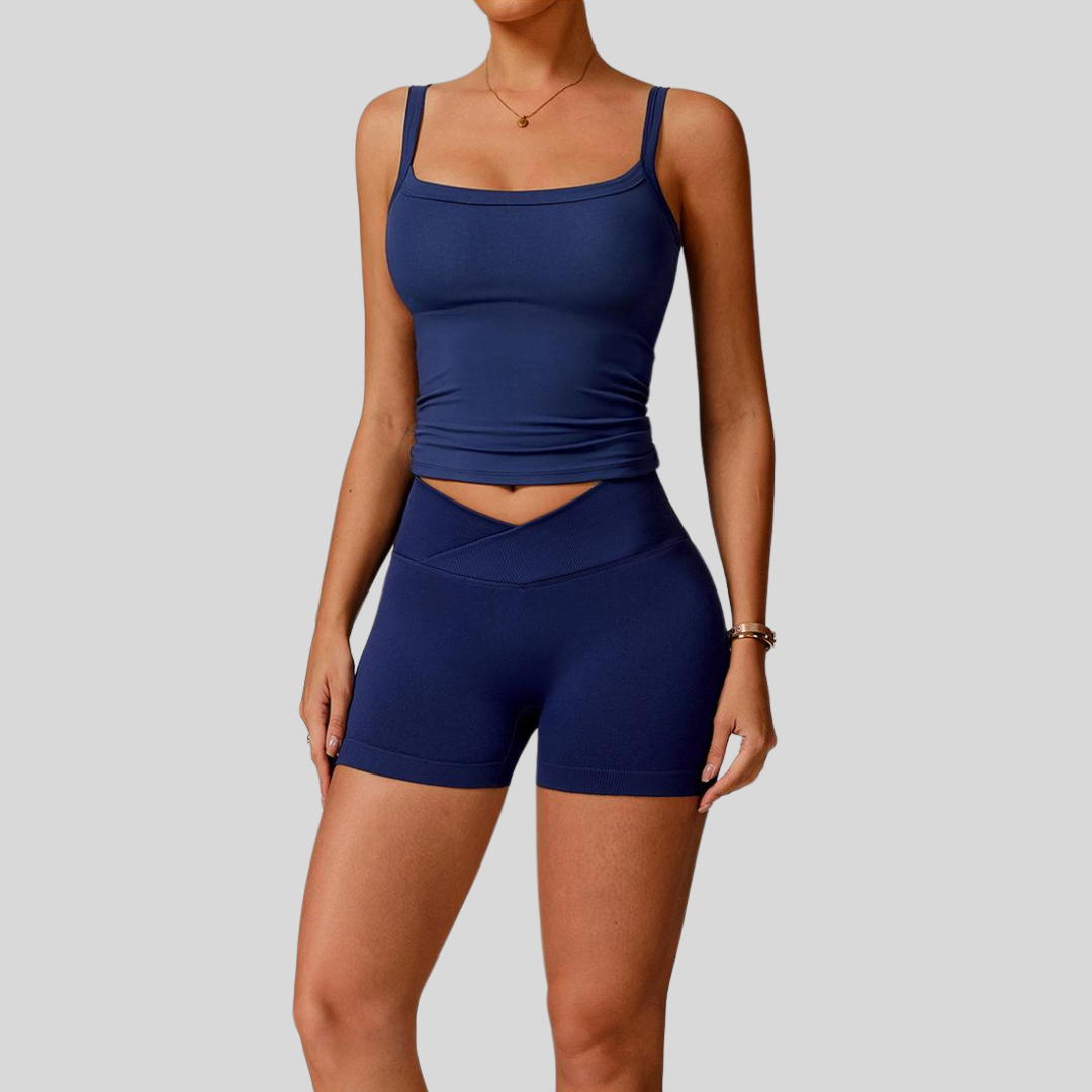 Model wearing Kaos The Label Zaya Set in Navy, showcasing front view of seamless activewear set