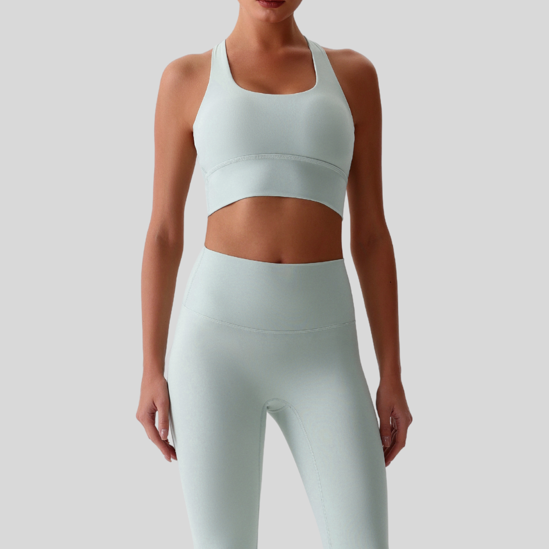 Model wearing Kaos The Label Isla Set in Light Green, showcasing front view of seamless activewear set