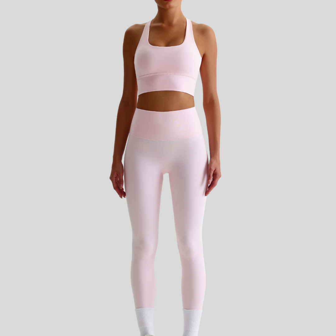 Model wearing Kaos The Label Isla Set in Pink, showcasing front view of seamless activewear set