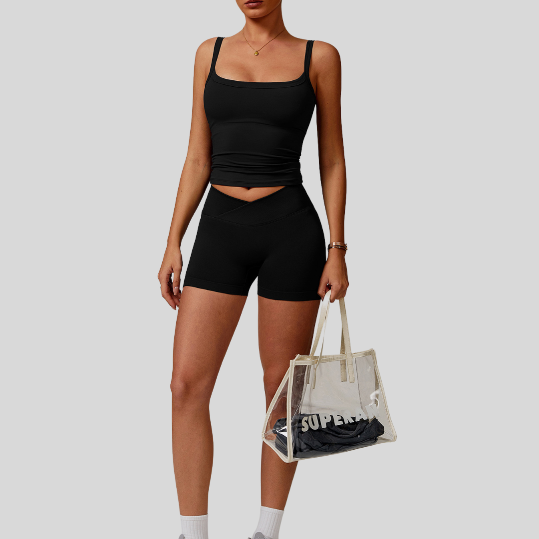 Model wearing Kaos The Label Zaya Set in Black, showcasing front view of seamless activewear set