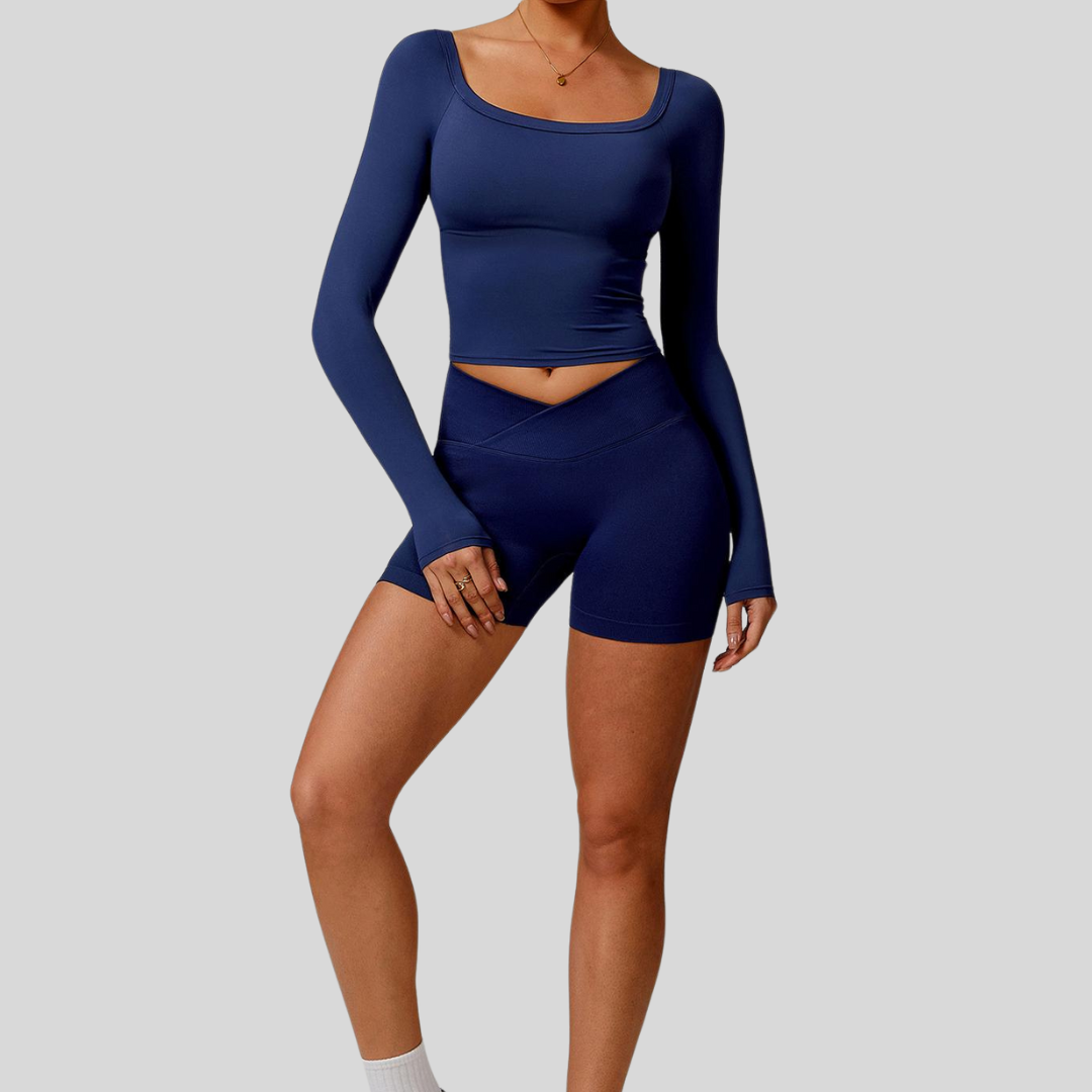 Model wearing Kaos The Label Cleo Set in Navy, showcasing front view of seamless activewear set